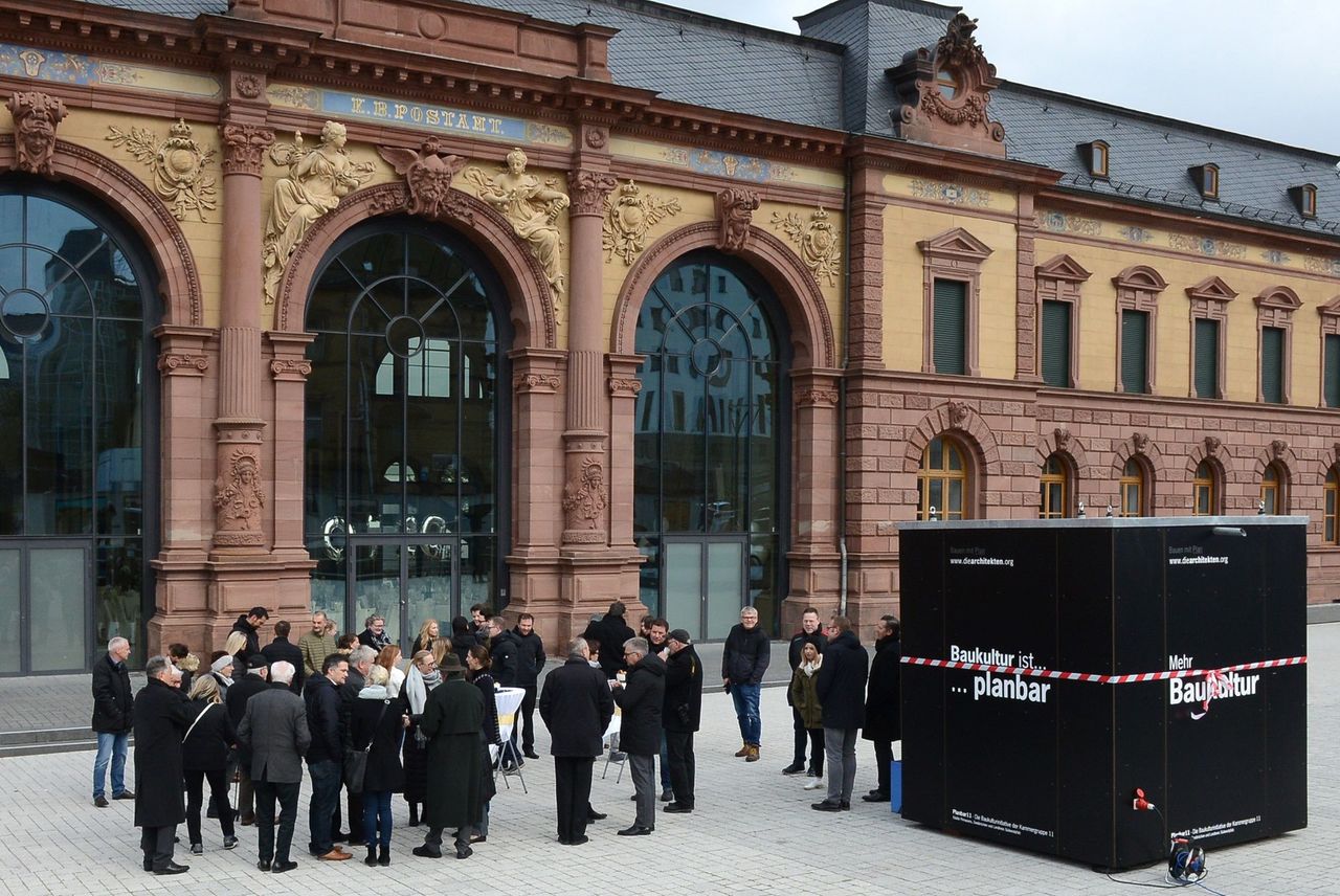 Menschen auf dem Platz, rechts im Bildvordergrund die Baukulturbox.