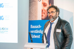 Holger Beger steht am rednerpult bei seinem Vortrag