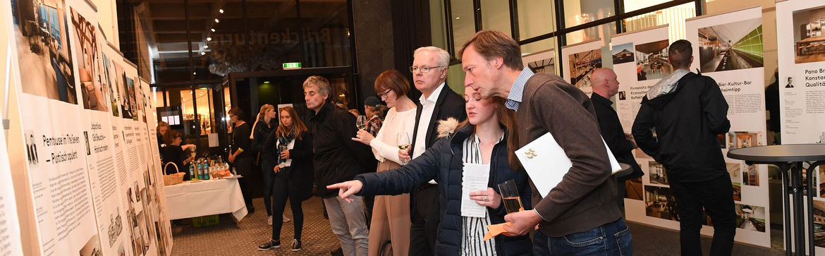 Mehrere Menschen tauschen sich bei der Eröffnung der „bdia Handbuch Ausstellung“ im Zentrum Baukultur aus.